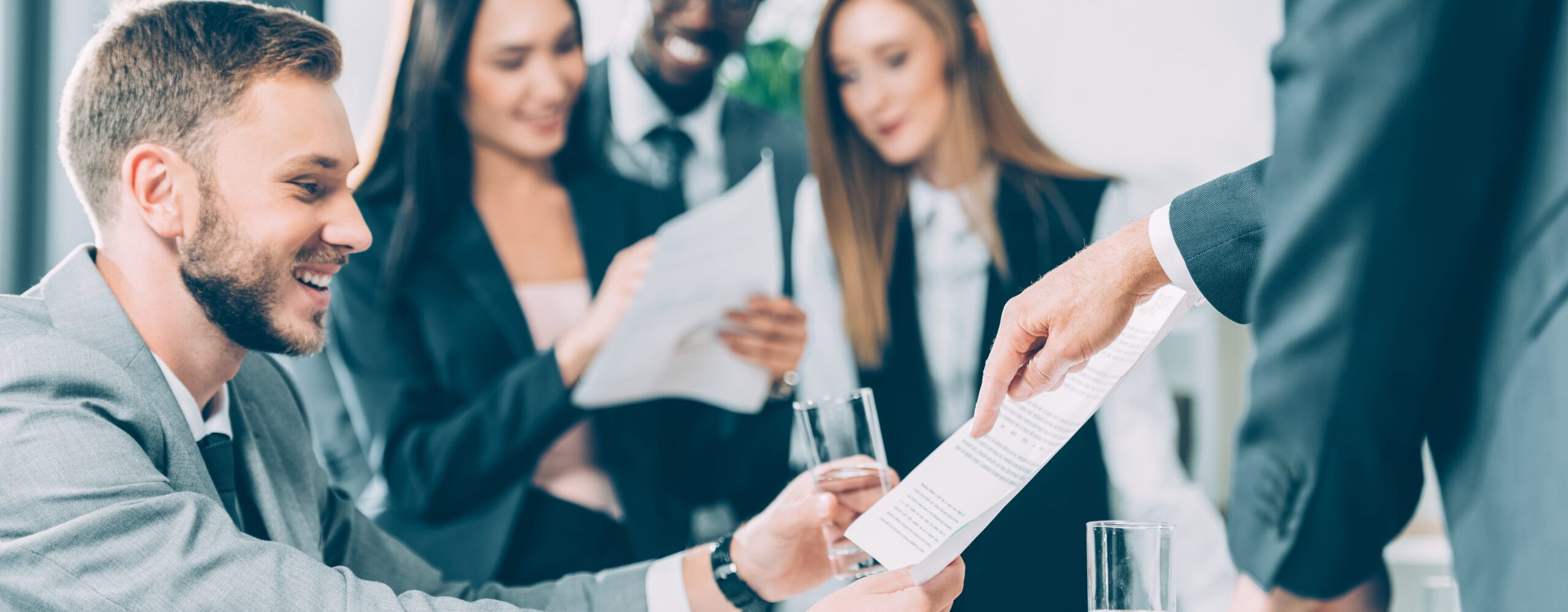 multiracial businesspeople exploring documents in modern office